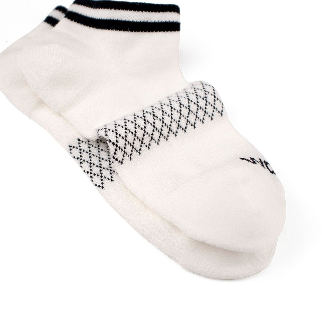 Folded view showing solid white ankle compression socks with black cuff stripes.